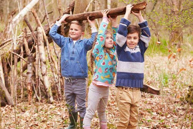 Three children prepare to make camp in the woods